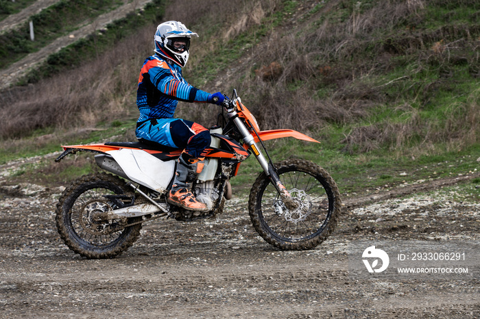 man riding a motocross in a protective suit