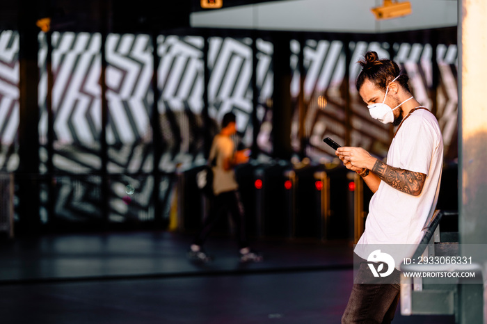 A young man checking coronavirus symptoms in his phone