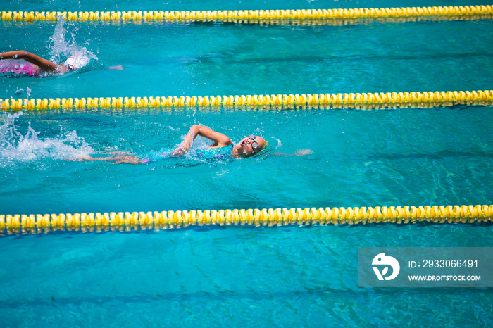 Athlete in freestyle swimming race in swimming pool