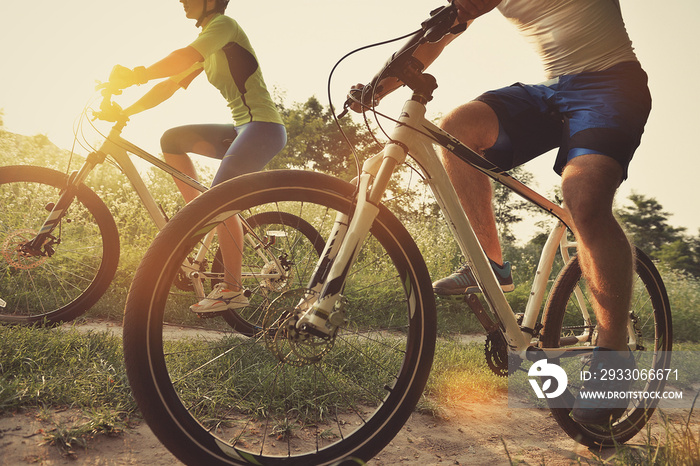 Man and woman riding bicycles in the field