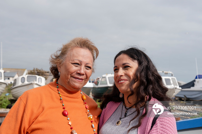 Portrait of smiling mother with daughter in harbor
