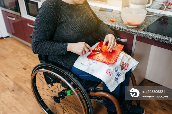 Disabled Woman Making salad In Kitchen