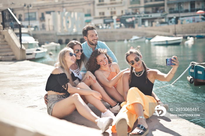 group of young people takes a selfie by the sea