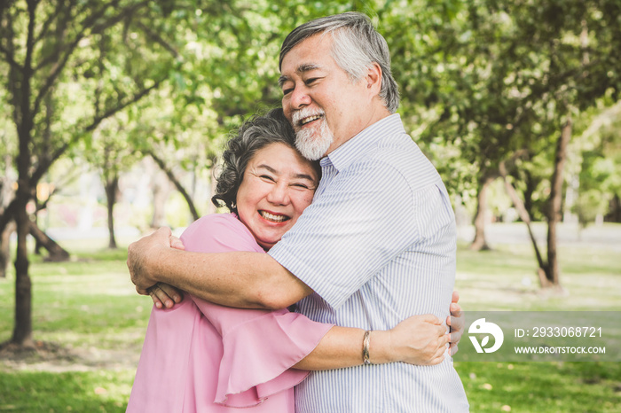 Happy elderly couple with lifestyle after retiree concept. Lovely asian seniors couple embracing together in the park in the morning.