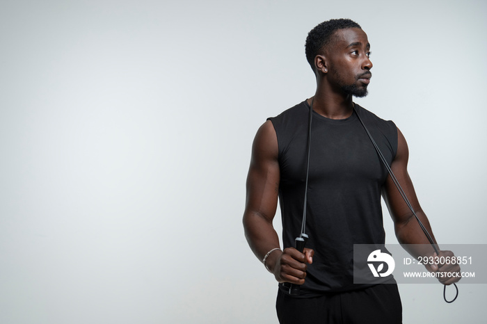 Portrait of man holding jump rope