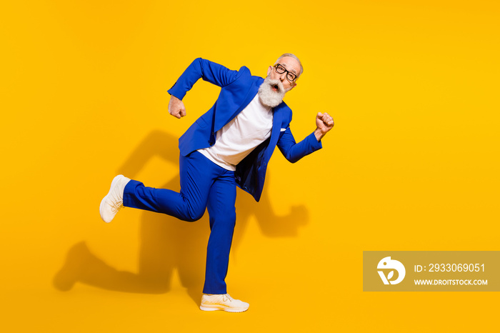 Full length body size view of attractive childish man running fooling having fun isolated over bright yellow color background