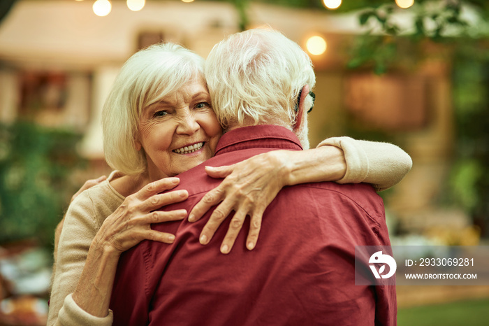 Elderly couple enjoying the evening while dancing