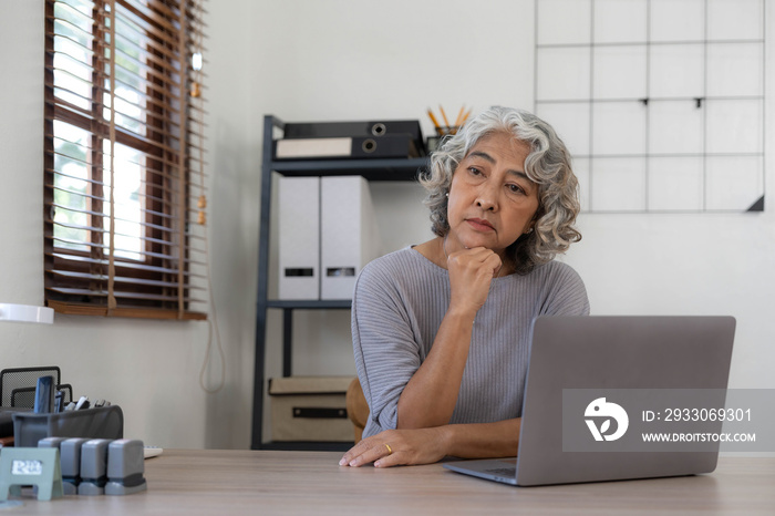 The elderly Asian woman sat in the home. she has stress and is sick. Retirement concept, senior health insurance