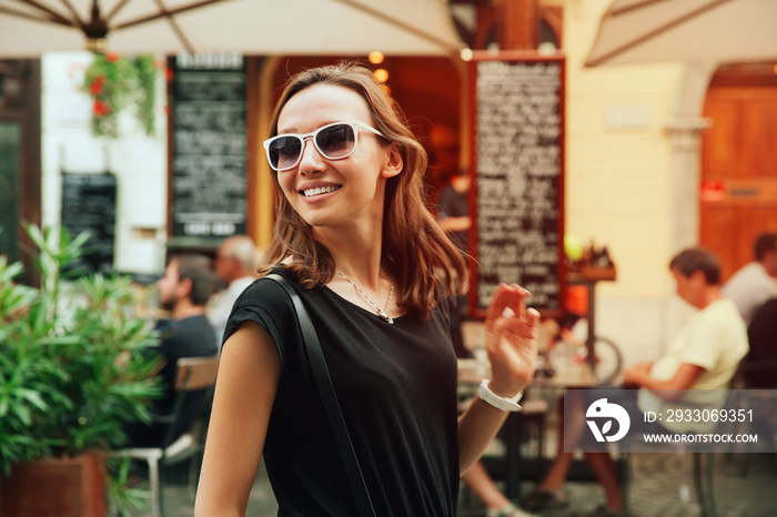 Smiling Woman on the Background of European Old Town Street.