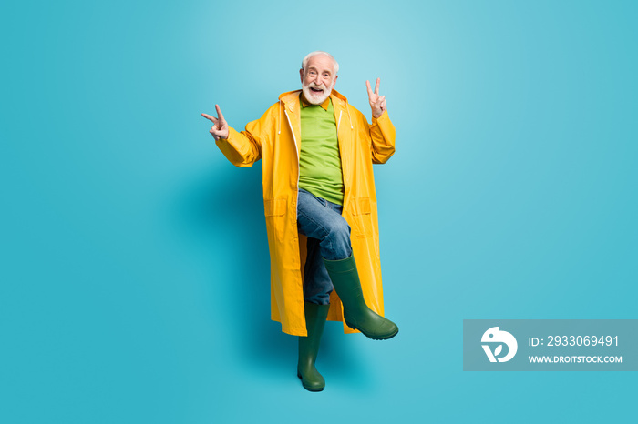 Full length body size view of his he nice cheerful cheery grey-haired man wearing topcoat dancing showing double v-sign good mood isolated over bright vivid shine vibrant blue color background