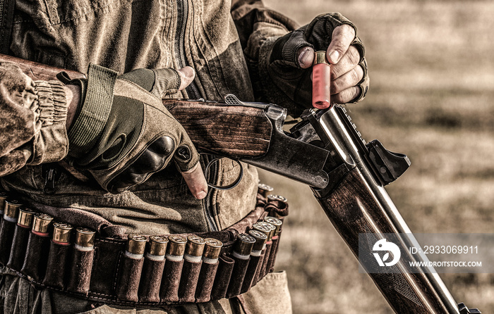 Process of hunting during hunting season. Male hunter in ready to hunt. Closeup. Hunter man. Hunting period. Male with a gun, rifle. Man is charging a hunting rifle