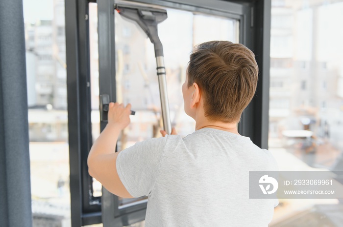 beautiful senior woman cleaning window glass.