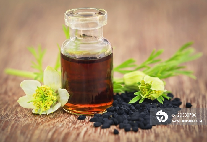 Nigella flower with seeds and essential oil