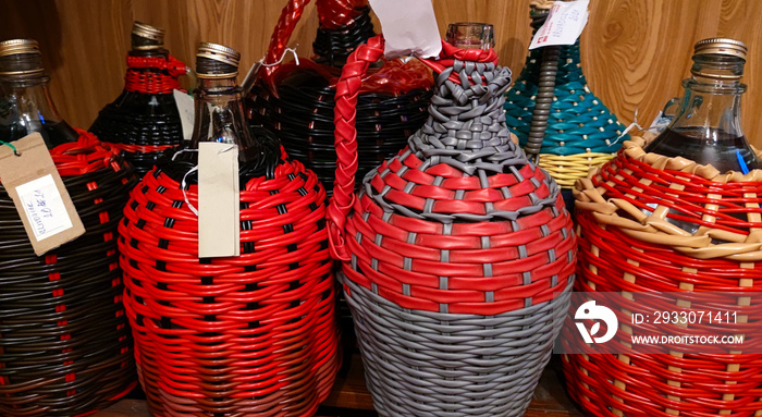 A close-up view of a demijohn with plum brandy after fresh burnt plum brandy