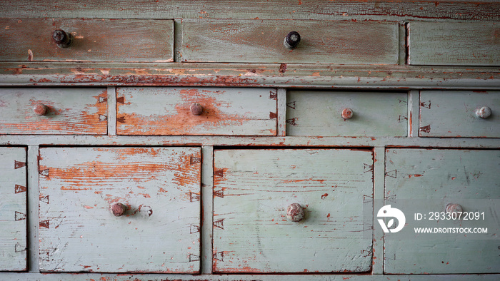 Old worn sideboard in light blue with many drawers and chipped paint. Copy space for your design. Web banner.