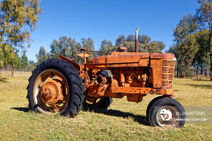 Old, abandoned tractor in field