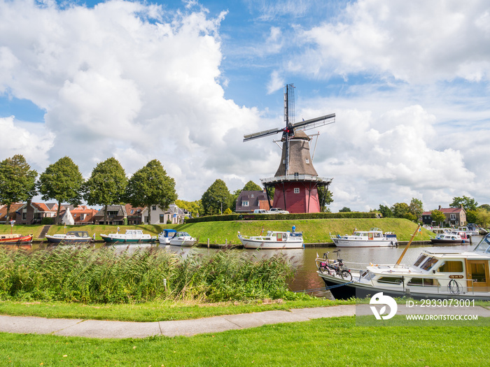 Canal and windmill on fortifications of fortified town of Dokkum, Friesland, Netherlands