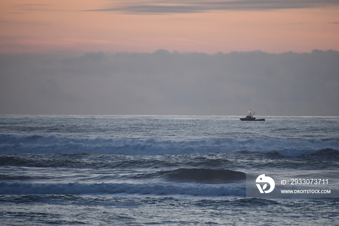 commercial fishing ship just off the coast