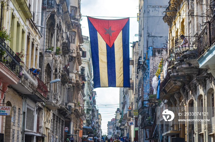 A Cuban flag hangs proudly from a balcony in the streets of Central Havana