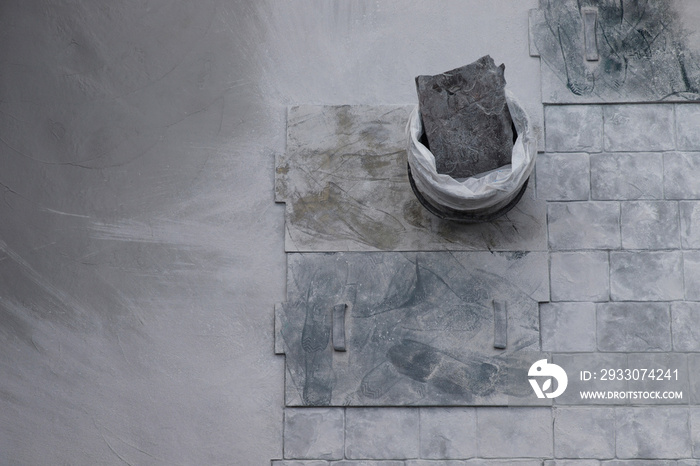 Worker working on gray concrete stamping floor at the construction agency