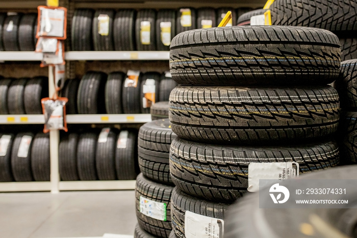 Car tires and wheels at warehouse in tire store.