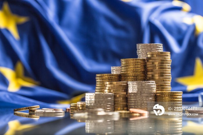 Towers with euro coins and flag of European Union in the background