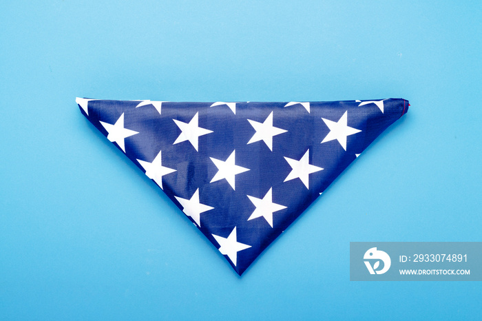 Folded USA flag on a blue background. Concept Memorial Day, Independence Day, July 4th. Flat lay, top view