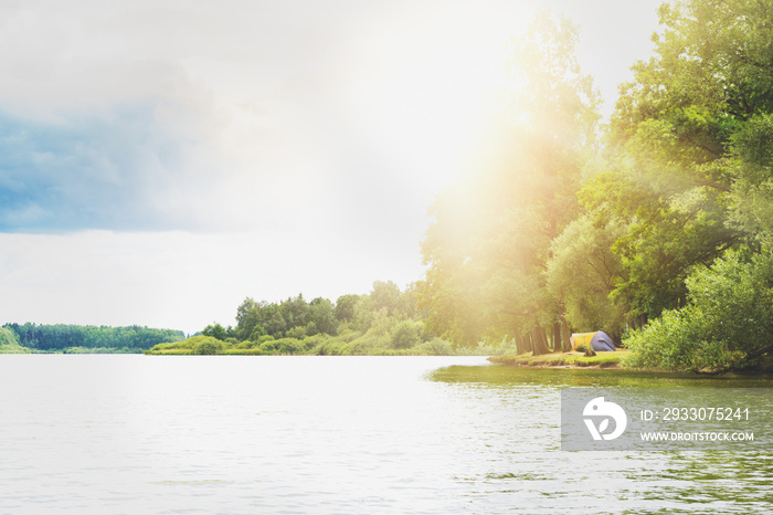 Camping tent near a beautiful lake, summer campsite, adventure family vacation concept