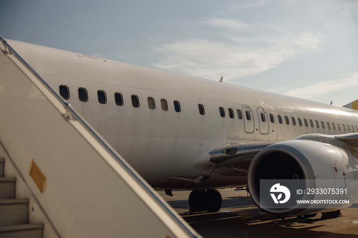 View of passenger aircraft body with windows and airstay from outside on a daytime. Plane, shipping, transportation concept