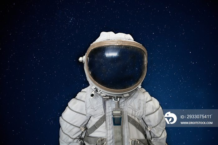 Soviet cosmonaut or astronaut or spaceman suit and helmet on black space with stars background