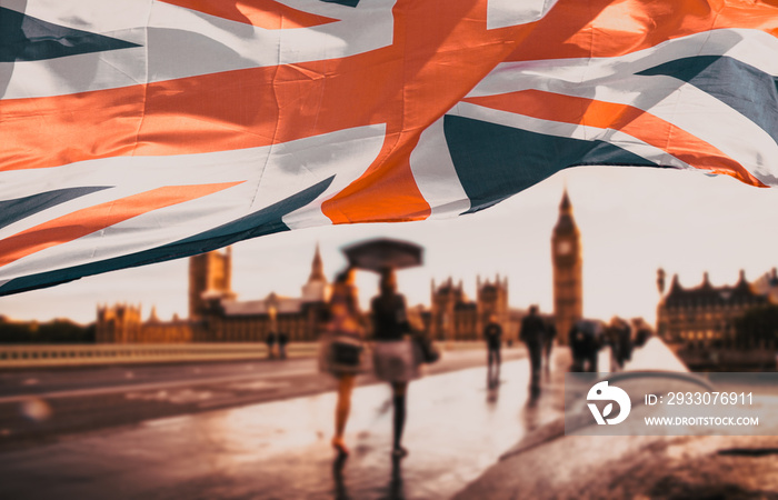 flag of UK waving in front of Big Ben and Westmister Abbey  London  UK