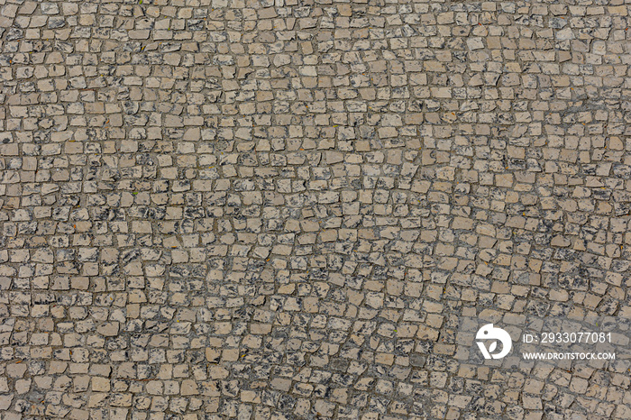 Typical classic footpath in city center of Lisbon, Old vintage stone ground with rough surface and dirty in Portugal, Seamless pattern of cubes blocks, Abstract texture background.