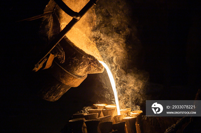 Industrial lost wax casting. The process of pouring for filling out ceramic shells with molten steel.