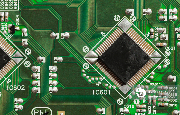 Microchip and capacitors are on a green printed circuit top view