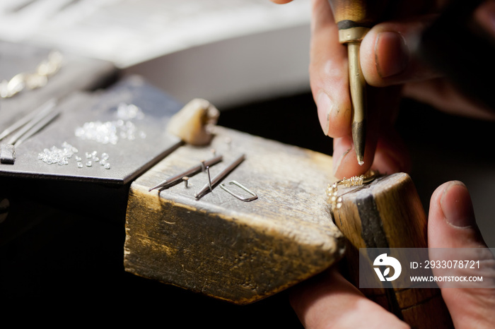 jeweller handmade work, crafting golden jewellery with tools, closeup