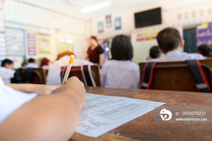 Education concept. The students are holding a pencil to write.