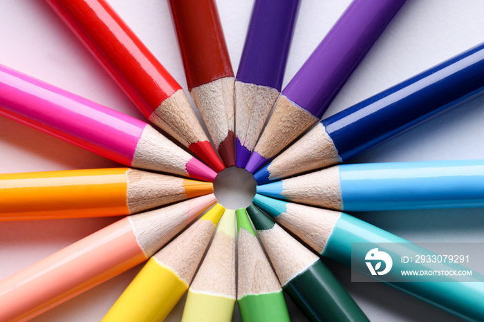 Multicolored pencils lying in shape of sun closeup