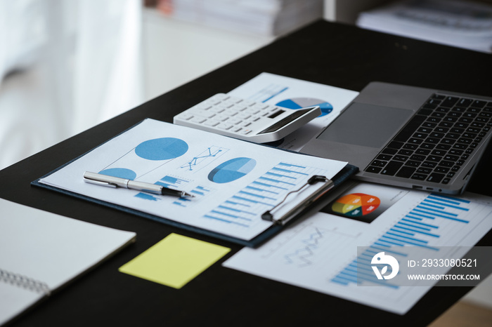 Close up of business hands working and calculating on financial and accounting graft and chart in office space.