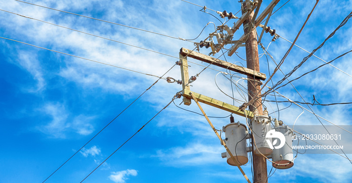 a electric pole with transformer and wire  the cloudy sky