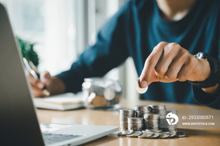 Man hands putting coins stack, Concept business finance saving money and investment.