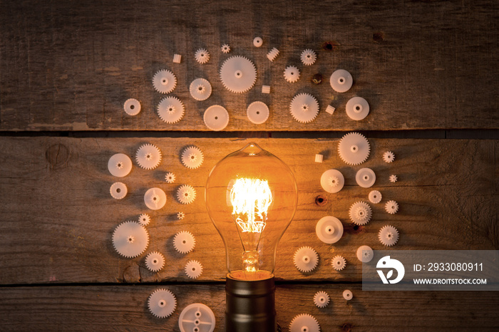 Idea and teamwork business concept, vintage incandescent light bulb and jigsaw on the wooden background