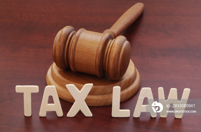 Tax laws concept. Words tax law and wooden judge gavel on table