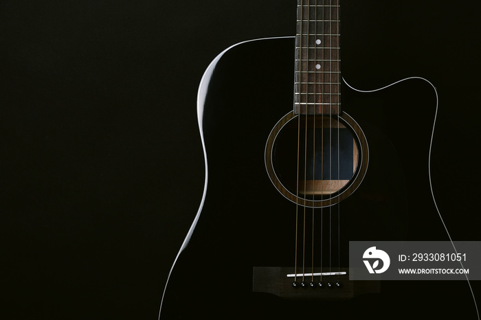 Black acoustic guitar studio shot on black background with copyspace, Guitar is favorite music instrument for hobby.