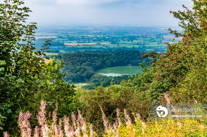 A tree framed view from Sutton Bank as storm clouds approach in Yorkshire, UK in summertime