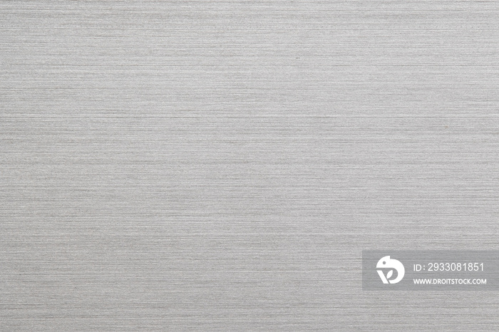 Shiny silver polished metal background texture of brushed stainless steel plate with the reflection of light.