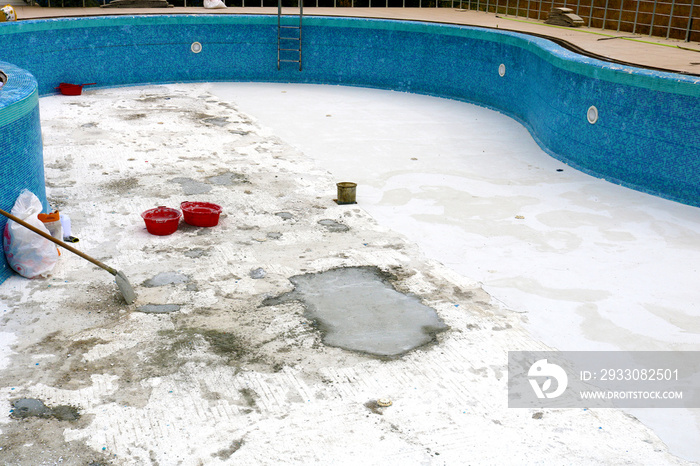 Swimming pool remodel. Laying construction of the swimming pool in the garden. New swimming pool construction site.