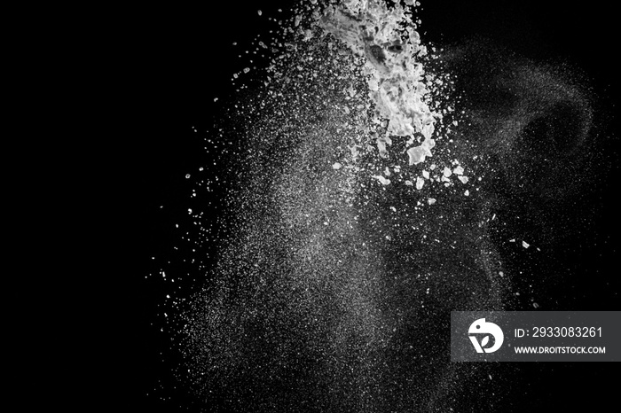 White dust similar to flour and snow is actively scattered isolated on black background