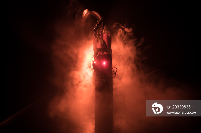 Image of a time bomb against dark background. Timer counting down to detonation illuminated in a shaft light shining through the darkness,