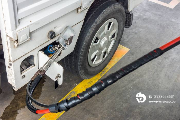 Fueling natural gas vehicle with CNG. It being filled in filling station in Thailand.