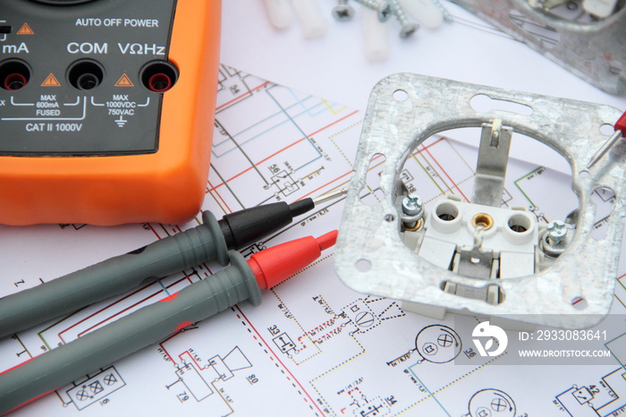 Sockets with a screwdriver and a measuring device on a circuit diagram